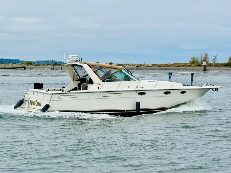 Slide: The Image of 1988 Tiara Yachts 3100 Open cruising on a calm river. - 48