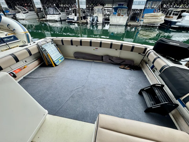 Slide: The Image of 1988 Tiara Yachts 3100 Open cruising on water, side view. - 5