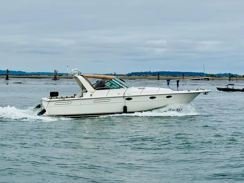 Slide: The Image of 1988 Tiara Yachts 3100 Open cruising on calm waters. - 50