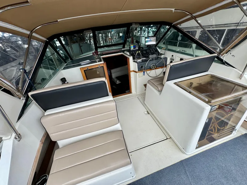Slide: The Image of 1988 Tiara Yachts 3100 Open interior with seating and helm station. - 9