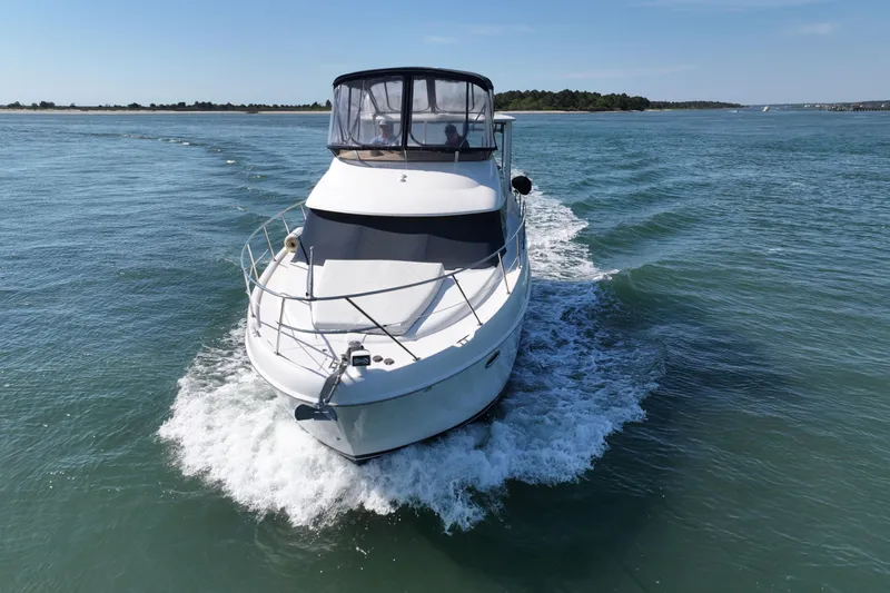 Slide: The Image of 2005 Meridian 368 Motoryacht cruising on open water under clear skies. - 11