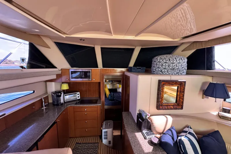 Slide: The Image of Interior of 2005 Meridian 368 Motoryacht with modern kitchen and cozy seating area. - 18