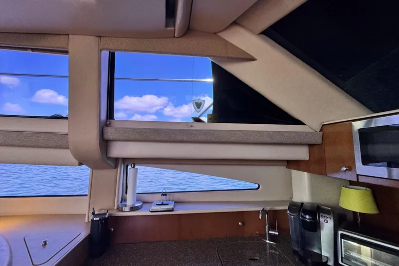 Slide: The Image of Interior view of 2005 Meridian 368 Motoryacht kitchen with ocean and sky visible. - 21