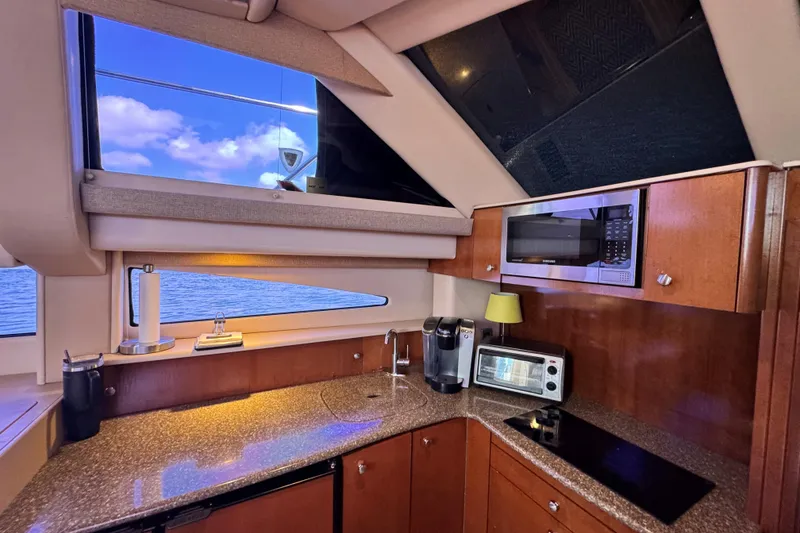 Slide: The Image of Luxurious kitchen interior of 2005 Meridian 368 Motoryacht with modern appliances and ocean view. - 22