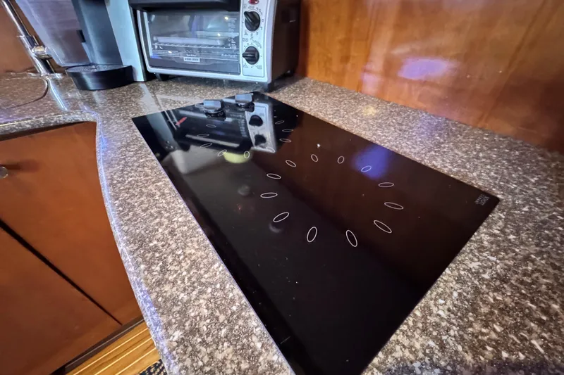 Slide: The Image of Modern kitchen in 2005 Meridian 368 Motoryacht with sleek black cooktop and toaster oven. - 26