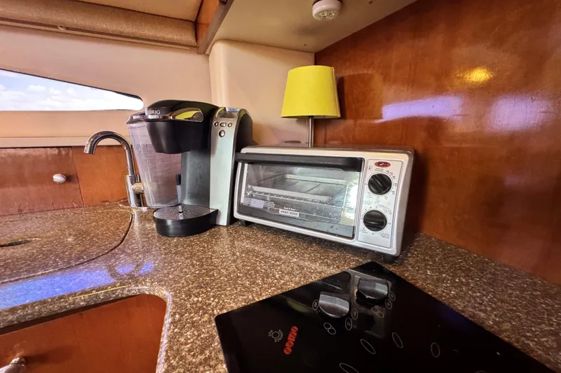 Slide: The Image of 2005 Meridian 368 Motoryacht kitchen with coffee maker, toaster oven, and stovetop. - 27