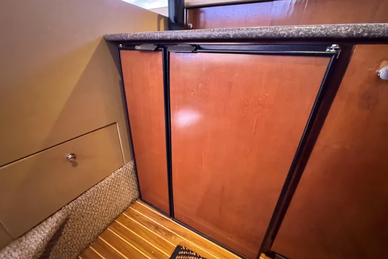 Slide: The Image of Wooden cabinetry in 2005 Meridian 368 Motoryacht interior, featuring sleek design and carpeted flooring. - 28
