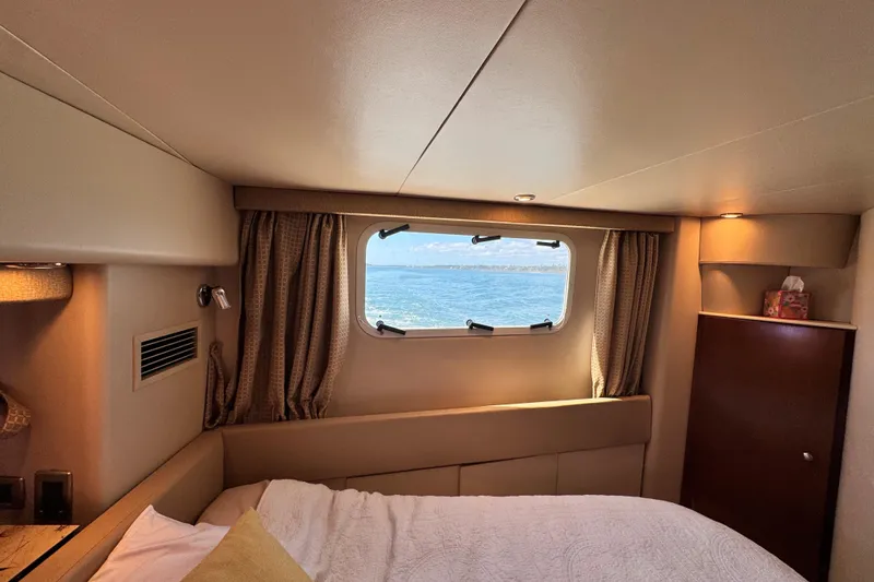 Slide: The Image of Interior cabin of 2005 Meridian 368 Motoryacht with ocean view through window. - 30