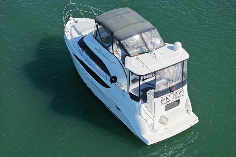 Slide: The Image of 2005 Meridian 368 Motoryacht cruising on clear green water, aerial view. - 5