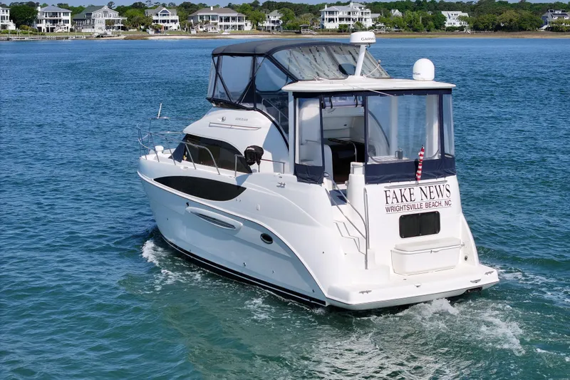 Slide: The Image of 2005 Meridian 368 Motoryacht cruising near Wrightsville Beach, NC, with scenic waterfront homes. - 8