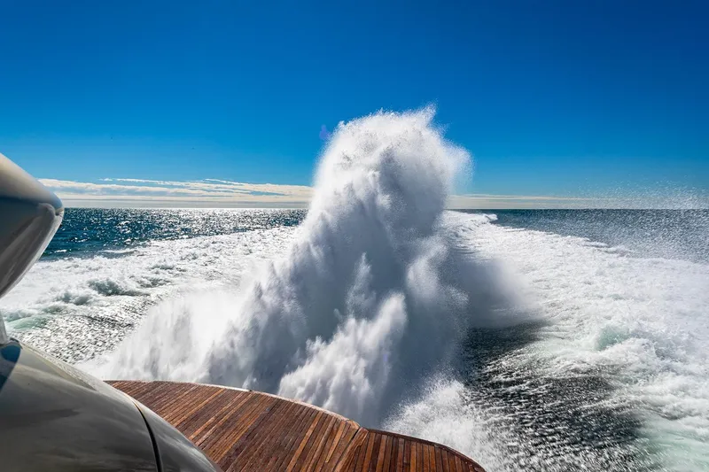 Slide: The Image of Powerful wake behind 2008 Pershing 90 yacht cruising on open sea under clear blue sky. - 11