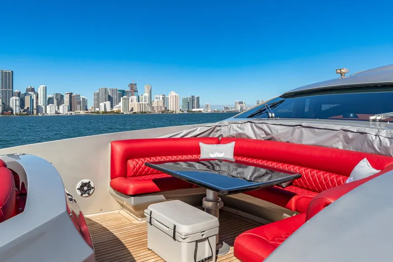 Slide: The Image of Luxurious 2008 Pershing 90 yacht with red seating, city skyline view, and blue sky. - 21