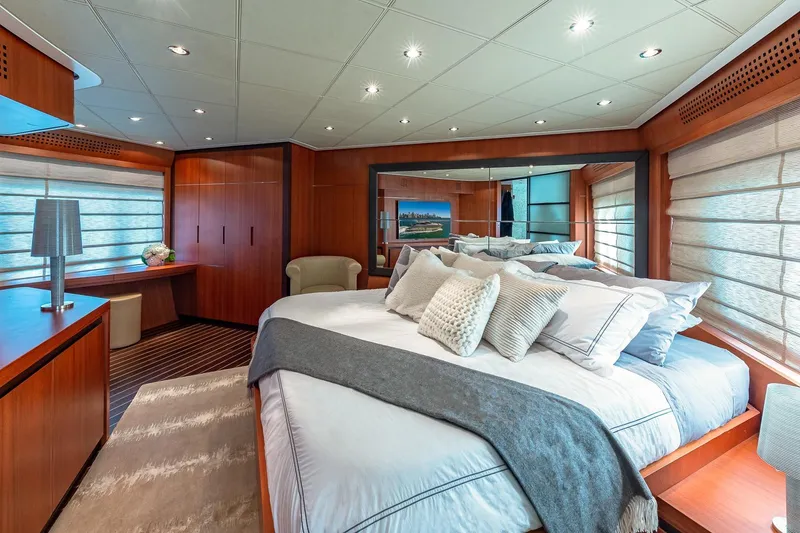 Slide: The Image of Luxurious 2008 Pershing 90 yacht bedroom with elegant wood paneling and plush bedding. - 34