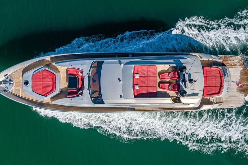 Slide: The Image of Aerial view of 2008 Pershing 90 yacht cruising on water with red seating. - 9