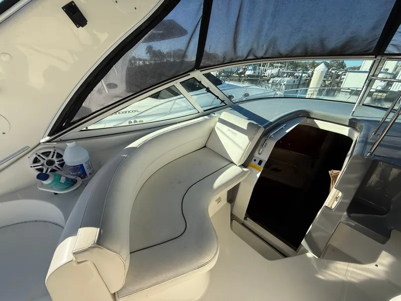 Slide: The Image of 2005 Cruisers Yachts 340 Express interior with white seating and helm. - 17