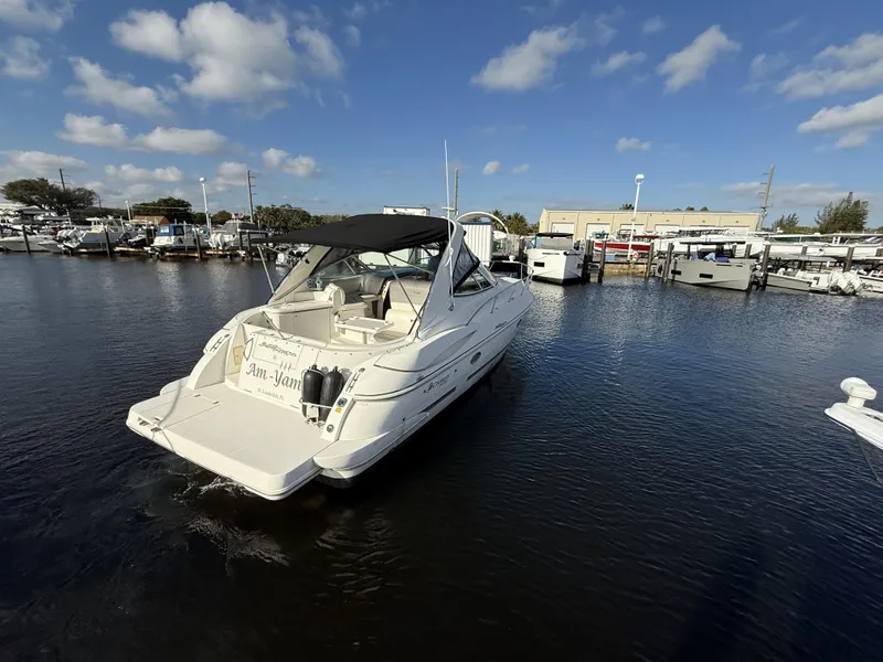 Slide: The Image of 2005 Cruisers Yachts 340 Express in marina, under clear blue sky. - 2