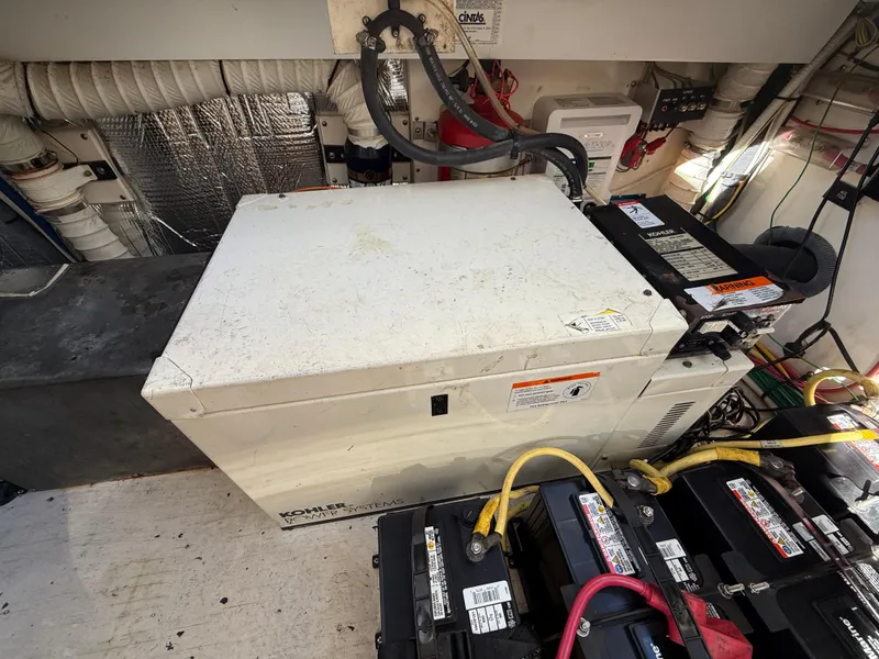 Slide: The Image of Engine room of 2005 Cruisers Yachts 340 Express with generator and batteries. - 27