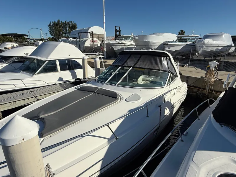 Slide: The Image of 2005 Cruisers Yachts 340 Express docked at marina under clear blue sky. - 3