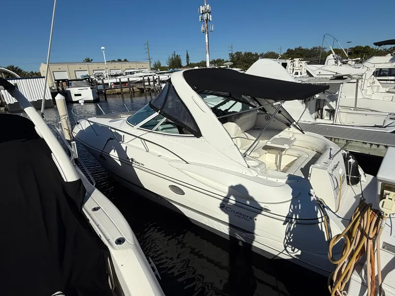 Slide: The Image of 2005 Cruisers Yachts 340 Express docked at marina under clear blue sky. - 4
