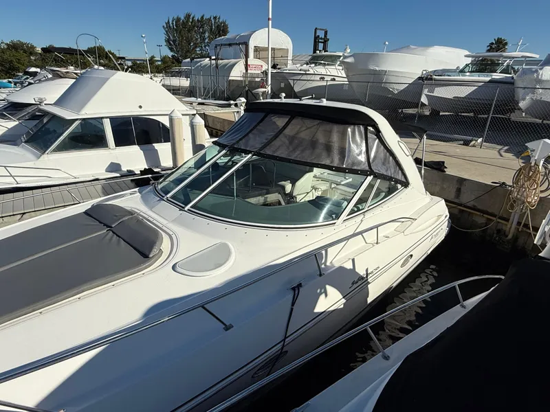 Slide: The Image of 2005 Cruisers Yachts 340 Express docked at a marina under clear skies. - 5