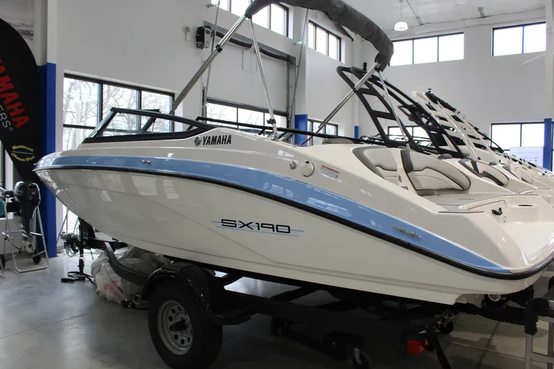 The Image of 2025 Yamaha Boats SX190 in showroom, sleek design with blue accents. - 0