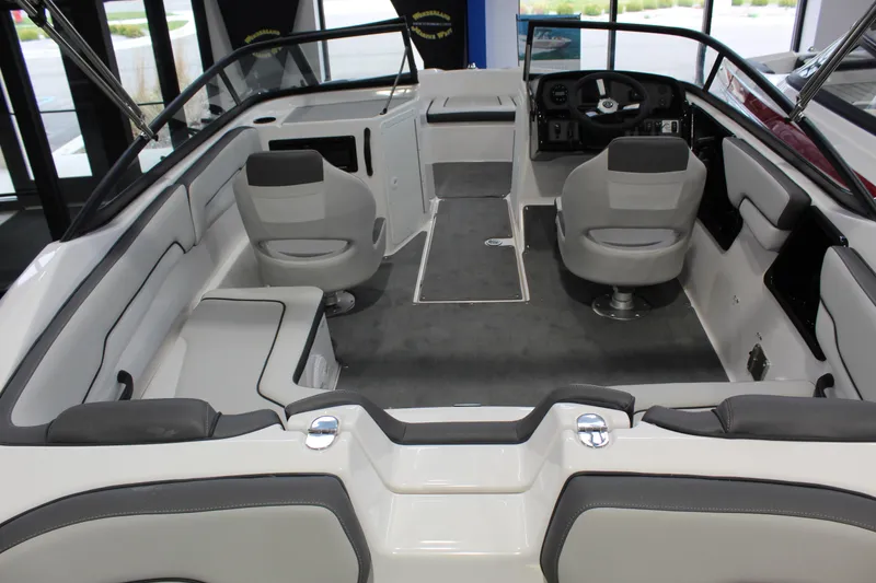Slide: The Image of 2025 Yamaha Boats SX190 interior with gray seating and modern dashboard design. - 2