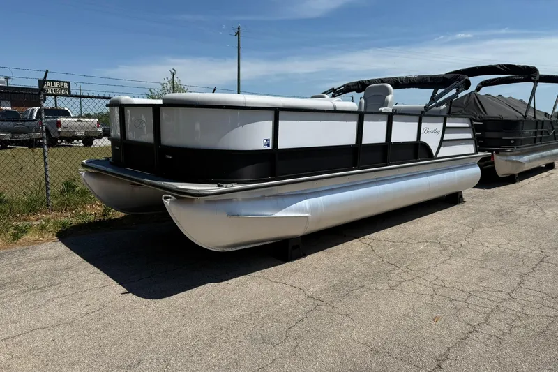 The Image of 2023 Bentley Pontoons 220 SWINGBACK pontoon boat parked on pavement under clear sky. - 0