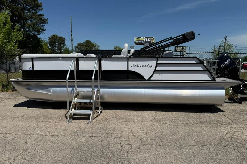 Slide: The Image of 2023 Bentley Pontoons 220 SWINGBACK pontoon boat with Suzuki motor, parked outdoors. - 3