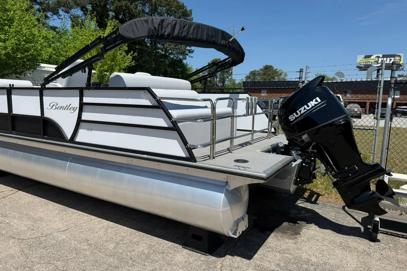 Slide: The Image of 2023 Bentley Pontoons 220 SWINGBACK with Suzuki outboard motor, parked outdoors. - 4