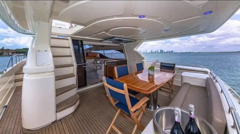 Slide: The Image of Luxurious 2005 Ferretti Yachts 680 with elegant deck dining area and ocean view. - 4