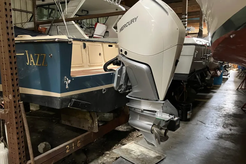 Slide: The Image of 2018 Rossiter 23 Classic Day Boat with Mercury outboard engine in storage. - 11