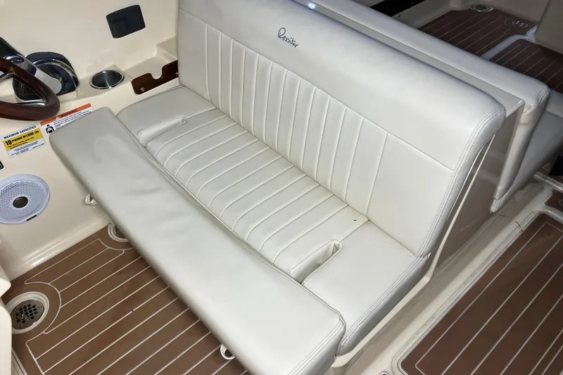 Slide: The Image of 2018 Rossiter 23 Classic Day Boat interior with white leather seating and wood accents. - 18