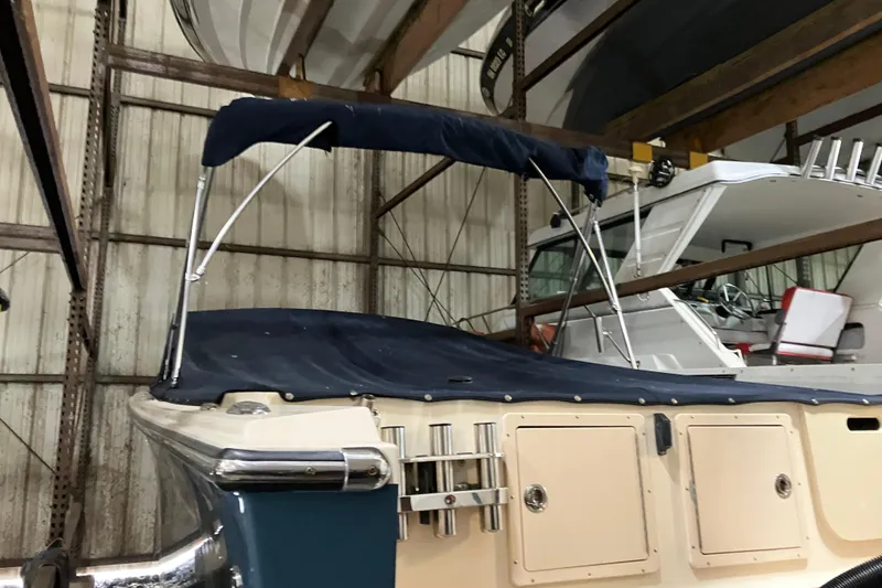 Slide: The Image of 2018 Rossiter 23 Classic Day Boat with blue canopy in storage. - 5