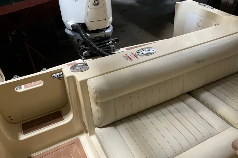 Slide: The Image of 2018 Rossiter 23 Classic Day Boat interior with beige seating and outboard motor. - 15