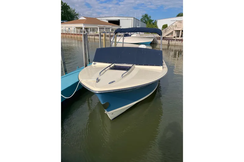 Slide: The Image of 2018 Rossiter 23 Classic Day Boat docked in calm waters. - 2