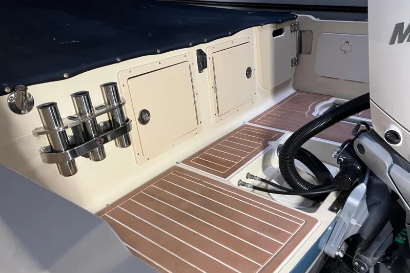 Slide: The Image of 2018 Rossiter 23 Classic Day Boat interior with rod holders and storage compartments. - 12