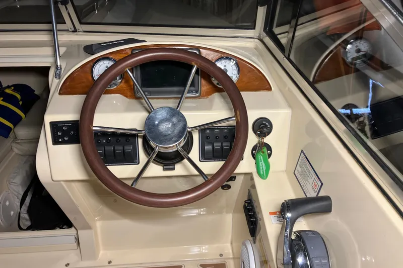 Slide: The Image of 2018 Rossiter 23 Classic Day Boat dashboard with wooden steering wheel and control panel. - 17
