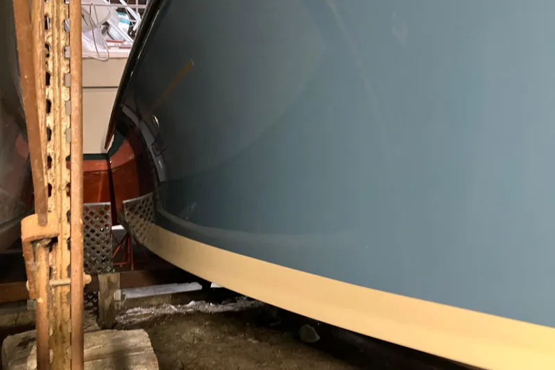 Slide: The Image of 2018 Rossiter 23 Classic Day Boat in storage, showcasing sleek blue hull design. - 9