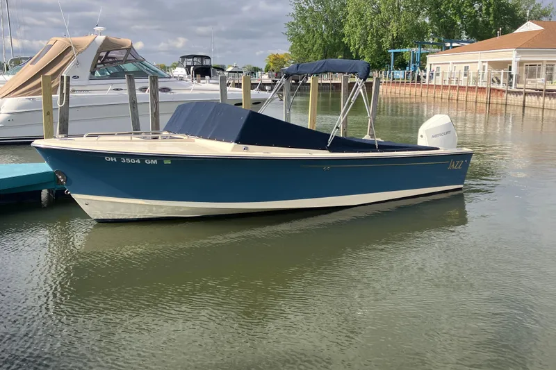 Slide: The Image of 2018 Rossiter 23 Classic Day Boat docked in a marina, featuring a blue hull. - 3