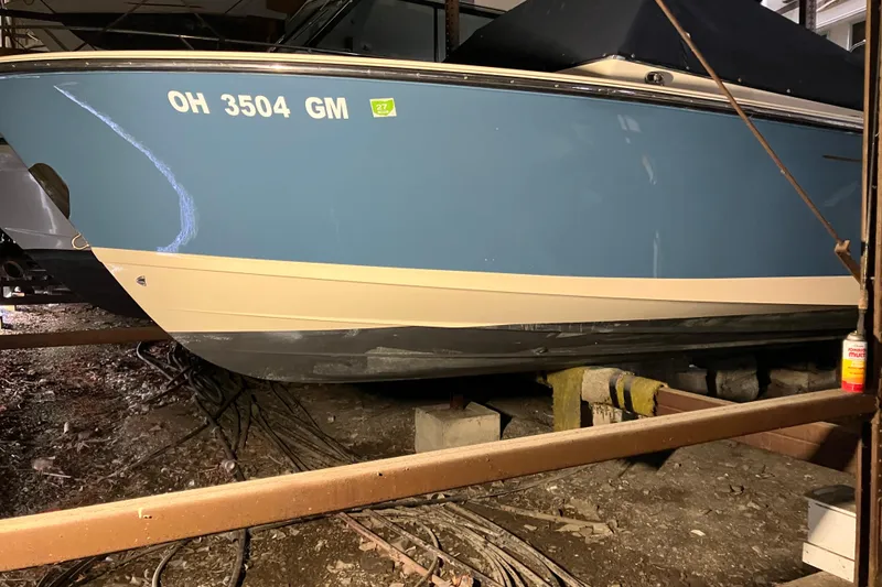 Slide: The Image of 2018 Rossiter 23 Classic Day Boat in storage, blue hull with registration number visible. - 8