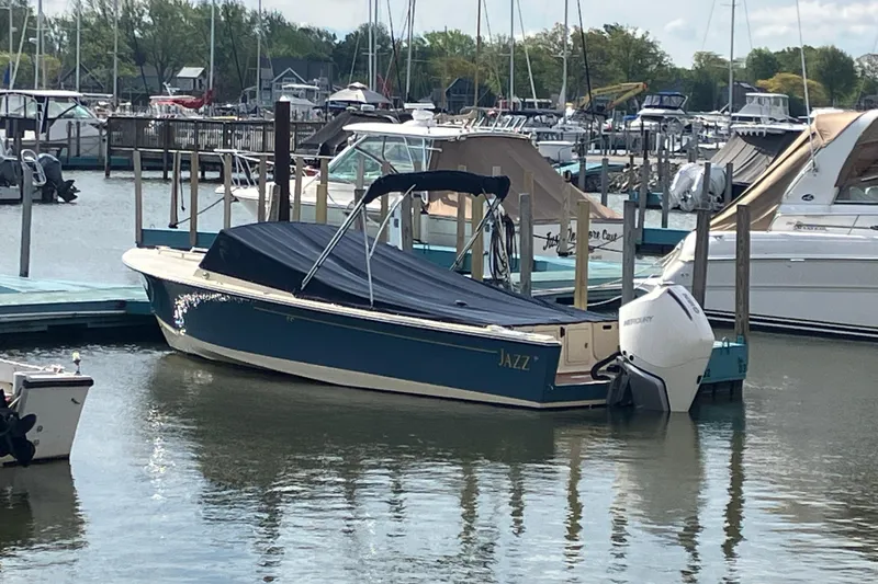 Slide: The Image of 2018 Rossiter 23 Classic Day Boat docked in a marina, covered and ready for use. - 4