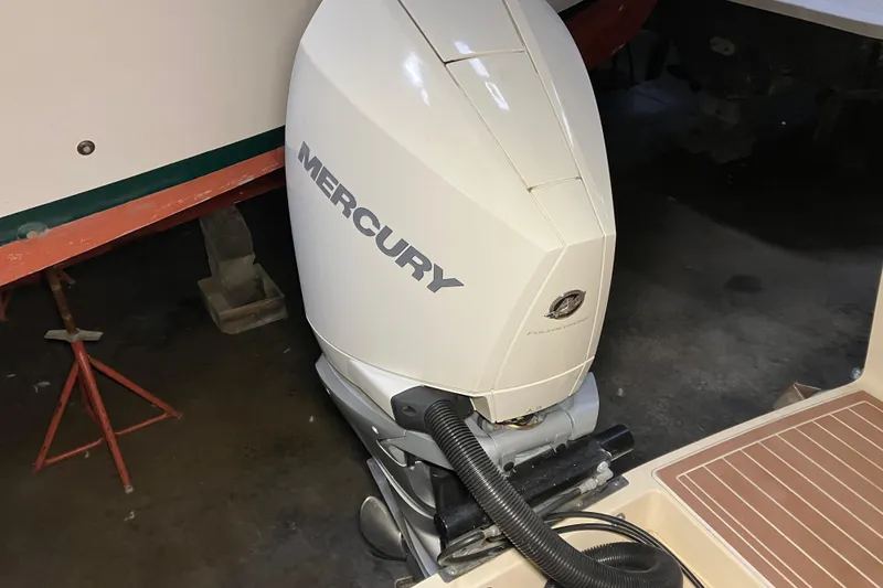 Slide: The Image of 2018 Rossiter 23 Classic Day Boat with Mercury outboard engine in a garage setting. - 13