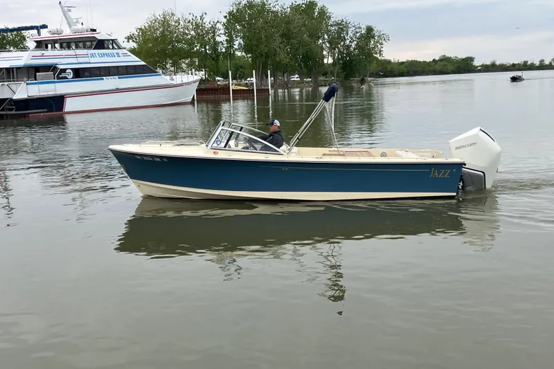 The Image of 2018 Rossiter 23 Classic Day Boat "Jazz" cruising on calm waters near a larger vessel. - 0