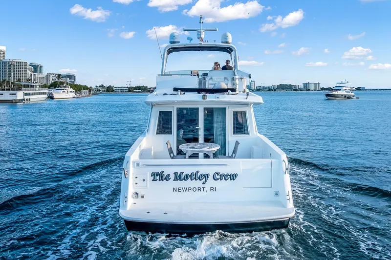 Slide: The Image of Navigator Rival 5700 yacht cruising in Newport, RI, with cityscape and blue sky. - 9