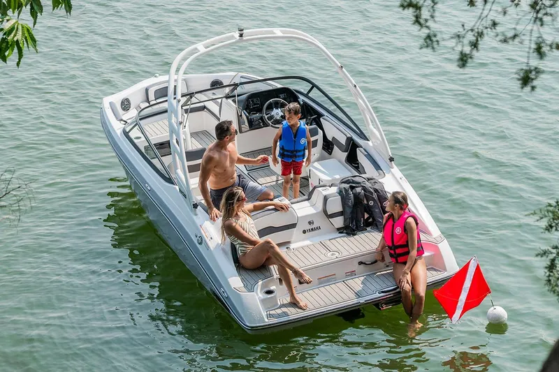 Slide: The Image of Manufacturer Provided Image: 2026 Yamaha Boats 195S with people enjoying a sunny day on the water. - 15