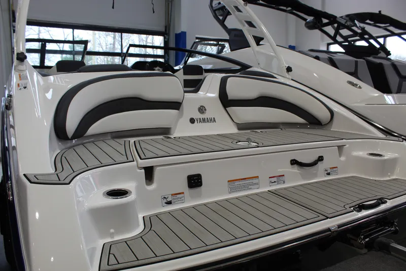 Slide: The Image of 2026 Yamaha Boats 195S with sleek seating and modern design in showroom. - 3