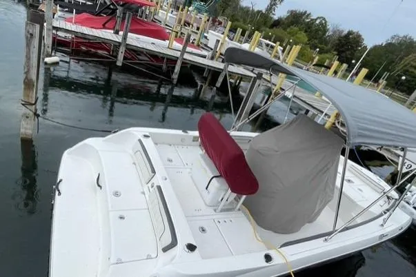 Slide: The Image of 2016 Yamaha Boats 190 FSH Deluxe docked, featuring a canopy and covered seating area. - 3