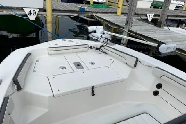 Slide: The Image of 2016 Yamaha Boats 190 FSH Deluxe docked, showcasing spacious deck and seating area. - 7