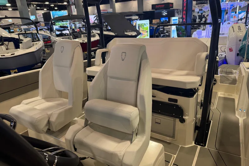 Slide: The Image of Interior of 2027 Navan T30 boat with modern seating at a boat show. - 13