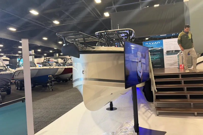 Slide: The Image of 2027 Navan T30 boat displayed at an indoor exhibition with informational signage. - 3